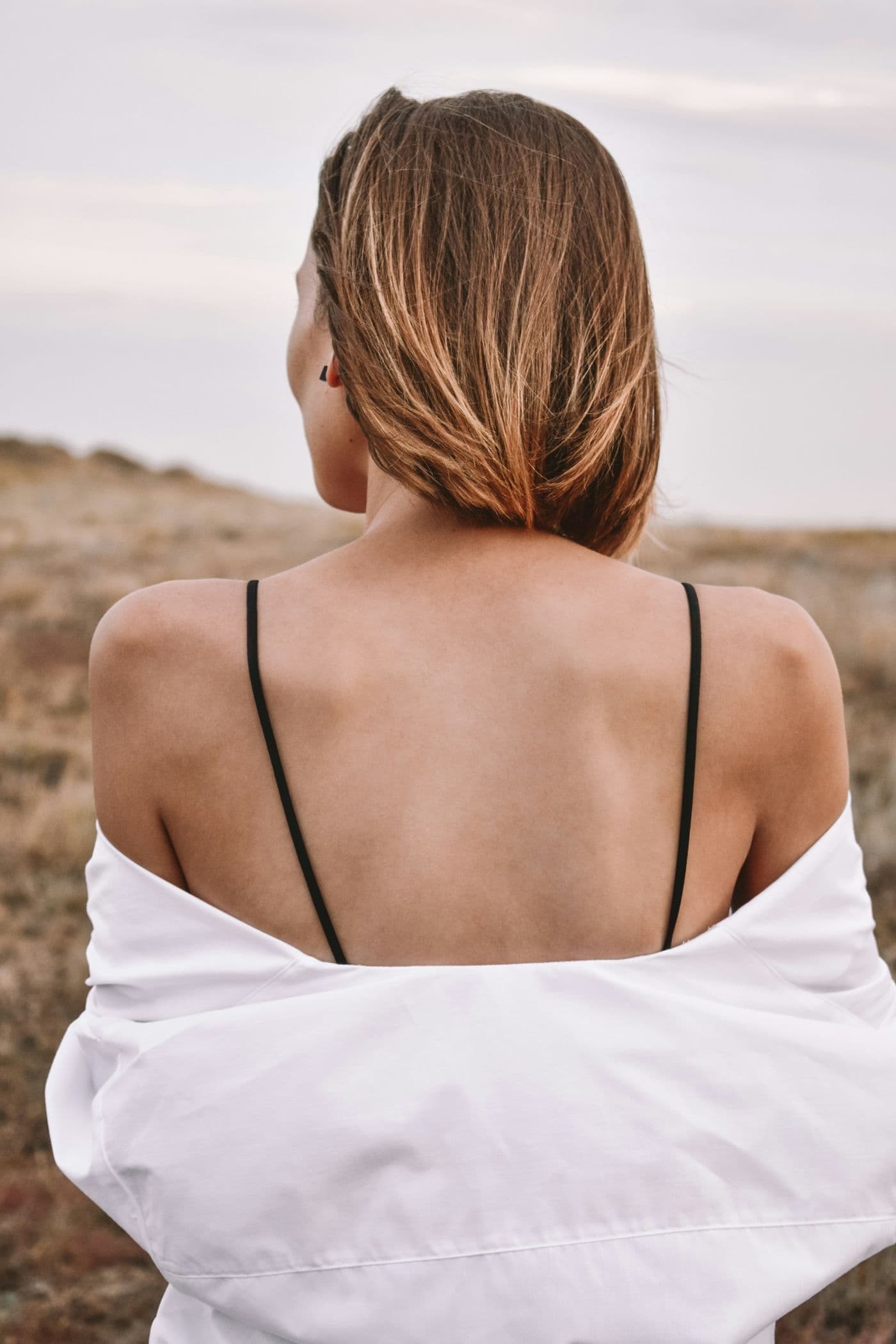 A woman on the beach seen from behind